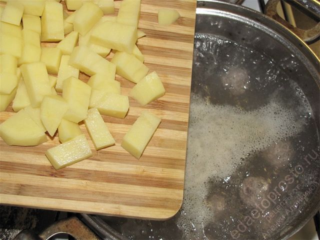Добавить в кипящую воду с фрикадельками подготовленный картофель, фото этапа приготовления сливочного супа с фрикадельками