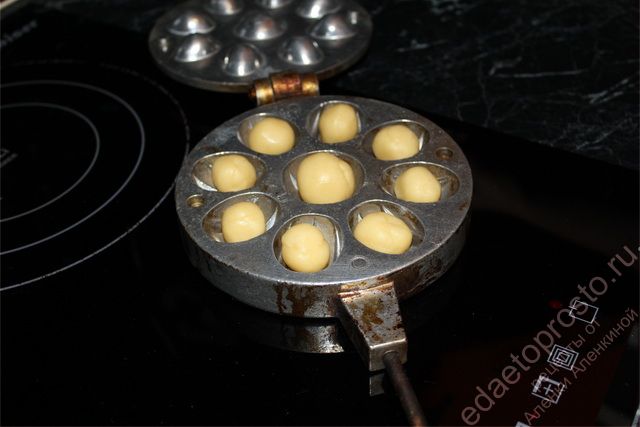В прокаленную орешницу выложить шарики теста, фото приготовления печенья